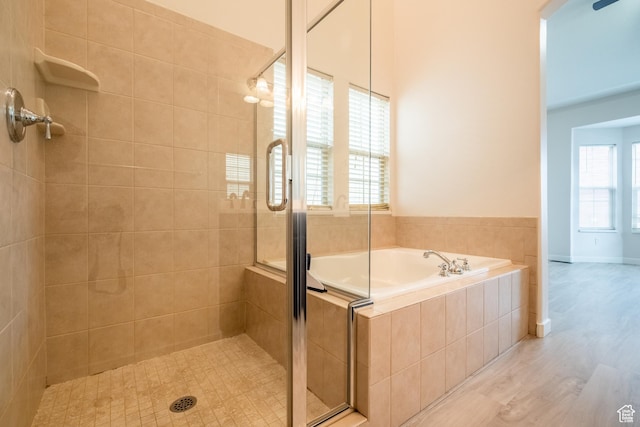 10227 S Oquirrh Lake Rd, South Jordan, UT 84095 - full bathroom with a stall shower, a garden tub, and wood finished floors