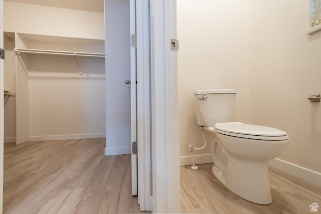 10227 S Oquirrh Lake Rd, South Jordan, UT 84095 - bathroom with toilet, wood finished floors, baseboards, and a walk in closet