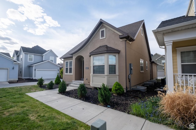 10227 S Oquirrh Lake Rd, South Jordan, UT 84095 - view of front of house with stucco siding, a garage, and a front yard