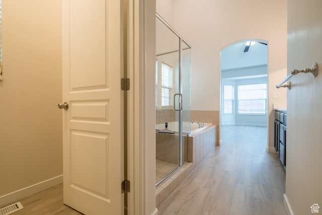 10227 S Oquirrh Lake Rd, South Jordan, UT 84095 - full bathroom with wood finished floors, a garden tub, a stall shower, baseboards, and vanity