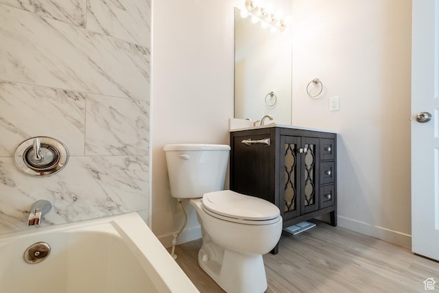 10227 S Oquirrh Lake Rd, South Jordan, UT 84095 - bathroom with a tub, baseboards, vanity, wood finished floors, and toilet