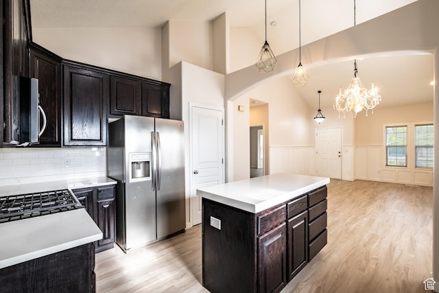 10227 S Oquirrh Lake Rd, South Jordan, UT 84095 - kitchen with appliances with stainless steel finishes, light wood-style floors, a chandelier, wainscoting, and light countertops
