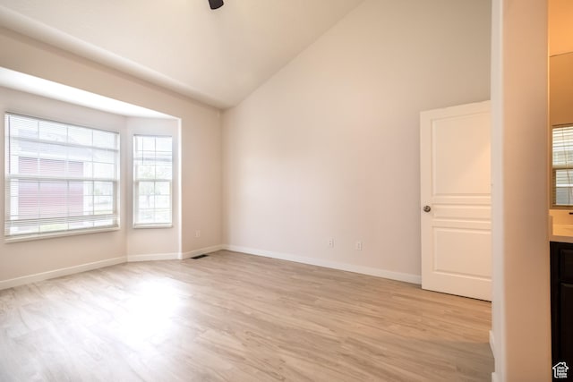 10227 S Oquirrh Lake Rd, South Jordan, UT 84095 - empty room with light wood-style floors, a ceiling fan, high vaulted ceiling, and baseboards