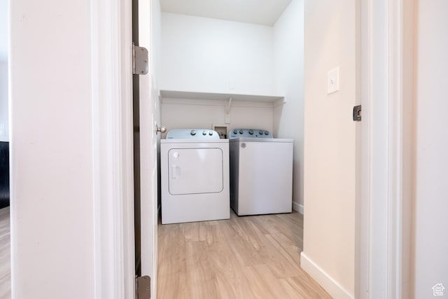 10227 S Oquirrh Lake Rd, South Jordan, UT 84095 - laundry room with washing machine and clothes dryer, light wood-style flooring, and baseboards