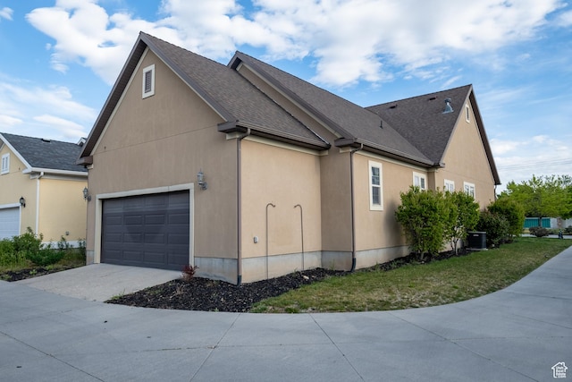 10227 S Oquirrh Lake Rd, South Jordan, UT 84095 - view of side of home with driveway, cooling unit, a garage, and roof with shingles