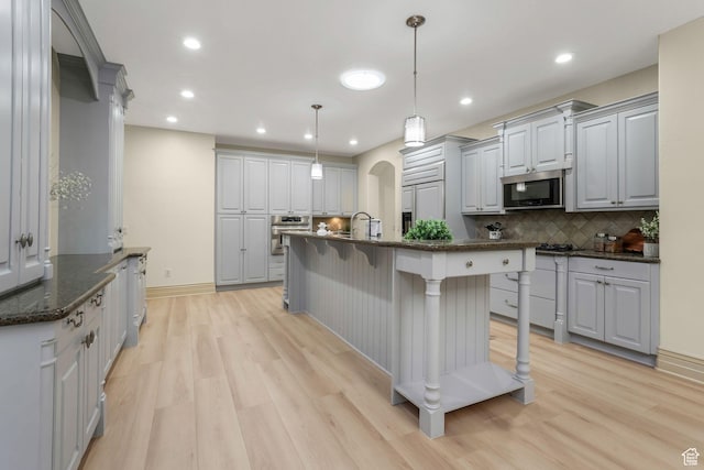 584 S Silver Ln, Alpine, UT 84004 - kitchen with appliances with stainless steel finishes, light wood-style flooring, decorative backsplash, recessed lighting, and gray cabinets