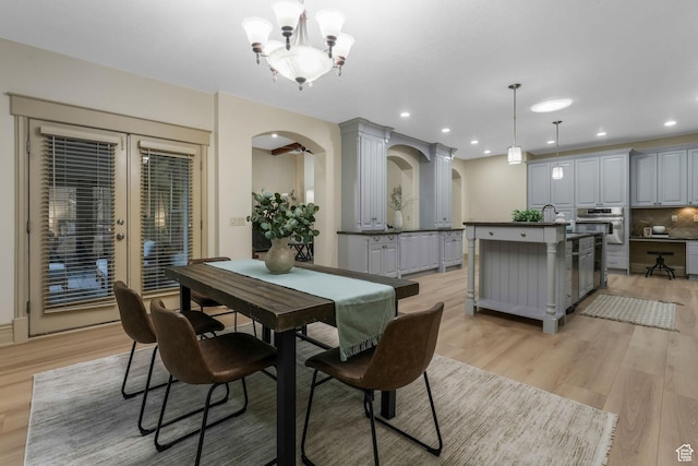 584 S Silver Ln, Alpine, UT 84004 - dining area featuring arched walkways, light wood-style floors, a chandelier, and recessed lighting