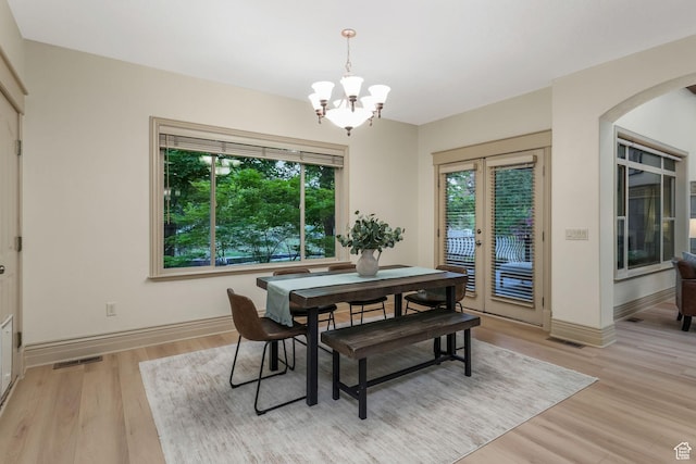 584 S Silver Ln, Alpine, UT 84004 - dining room featuring a chandelier, light wood finished floors, arched walkways, and french doors
