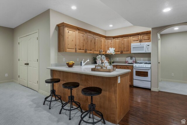 584 S Silver Ln, Alpine, UT 84004 - kitchen featuring white appliances, baseboards, arched walkways, light countertops, and recessed lighting