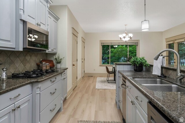 584 S Silver Ln, Alpine, UT 84004 - kitchen with stainless steel microwave, a sink, a chandelier, black gas cooktop, and plenty of natural light