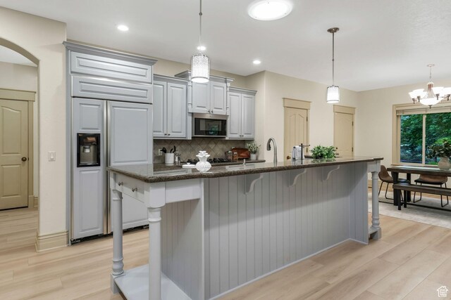 584 S Silver Ln, Alpine, UT 84004 - kitchen featuring stainless steel microwave, paneled refrigerator, light wood-style flooring, backsplash, and recessed lighting