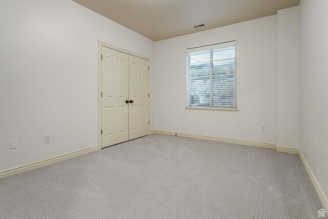 584 S Silver Ln, Alpine, UT 84004 - unfurnished bedroom featuring carpet flooring, baseboards, and a closet
