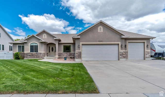 3028 W Viola Ln, Riverton, UT 84065 - view of front facade with stucco siding, stone siding, a garage, and driveway