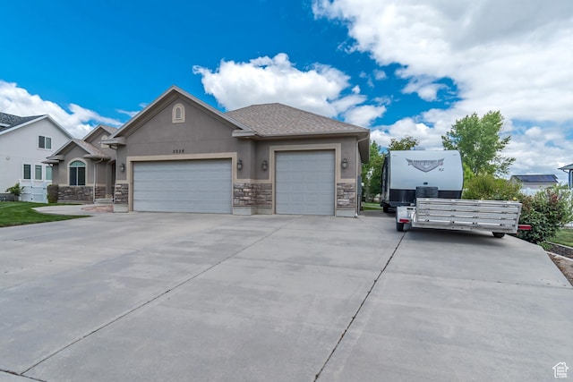 3028 W Viola Ln, Riverton, UT 84065 - view of front of home featuring stucco siding, stone siding, an attached garage, and concrete driveway