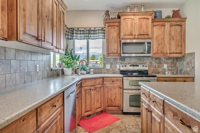 3028 W Viola Ln, Riverton, UT 84065 - kitchen with stainless steel appliances, light countertops, decorative backsplash, and a sink