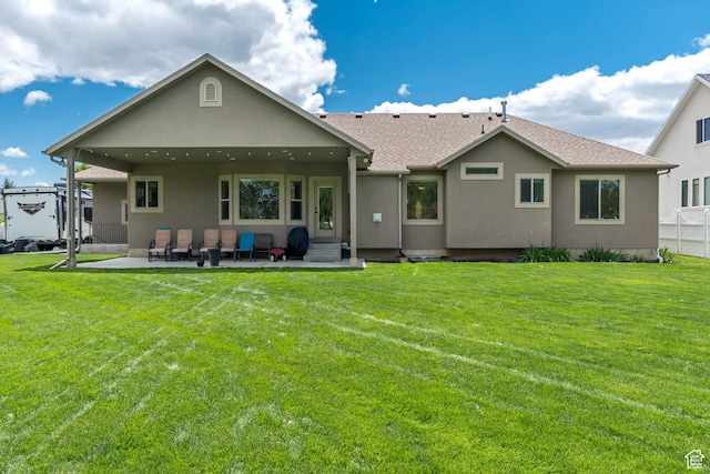 3028 W Viola Ln, Riverton, UT 84065 - back of property featuring a patio, a lawn, stucco siding, and entry steps