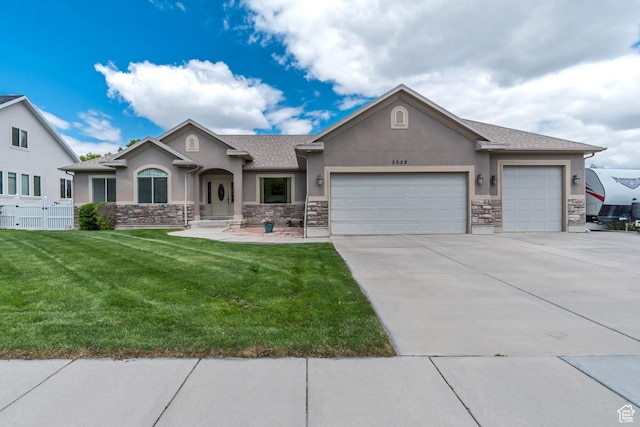 3028 W Viola Ln, Riverton, UT 84065 - view of front of house with stucco siding, stone siding, an attached garage, and driveway