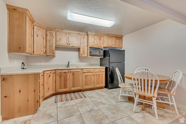 3028 W Viola Ln, Riverton, UT 84065 - kitchen with black appliances, light brown cabinets, a sink, light countertops, and a textured ceiling