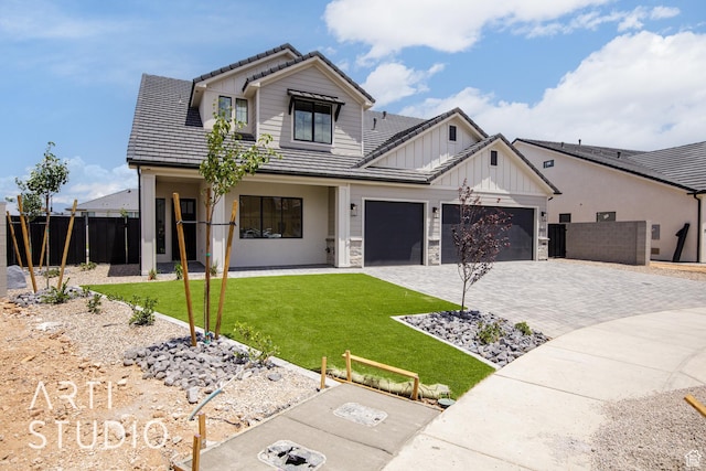 2921 E Yavin Way, St George, UT 84790 - modern farmhouse featuring a tiled roof, decorative driveway, board and batten siding, a garage, and stone siding