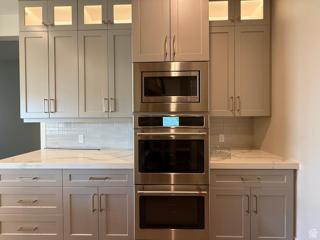 2921 E Yavin Way, St George, UT 84790 - kitchen featuring appliances with stainless steel finishes, backsplash, and gray cabinets