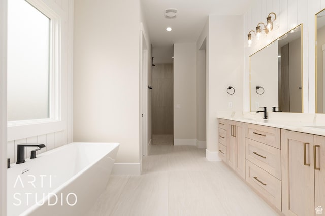 2921 E Yavin Way, St George, UT 84790 - bathroom featuring a freestanding tub, double vanity, a tile shower, baseboards, and recessed lighting