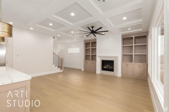 2921 E Yavin Way, St George, UT 84790 - unfurnished living room with plenty of natural light, light wood-style floors, coffered ceiling, stairway, and built in features