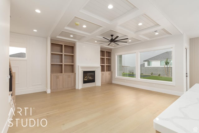 2921 E Yavin Way, St George, UT 84790 - unfurnished living room featuring light wood-style floors, coffered ceiling, beam ceiling, a glass covered fireplace, and recessed lighting
