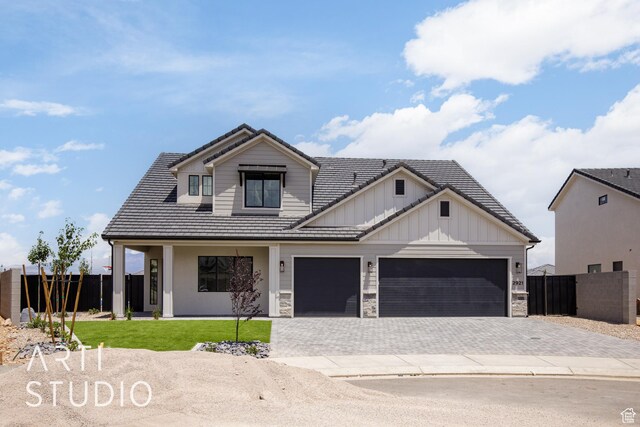 2921 E Yavin Way, St George, UT 84790 - modern inspired farmhouse featuring board and batten siding, decorative driveway, a garage, and a tile roof