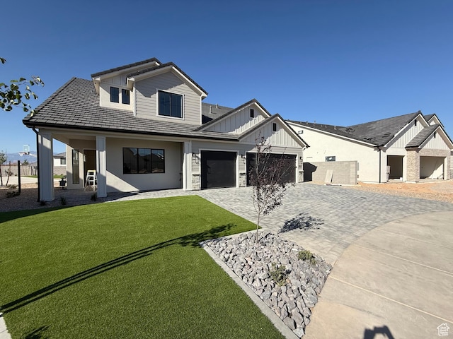 2921 E Yavin Way, St George, UT 84790 - modern inspired farmhouse featuring board and batten siding, decorative driveway, a front yard, an attached garage, and a porch