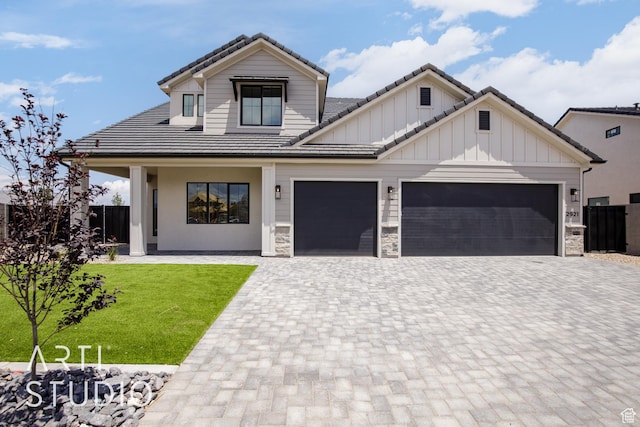 2921 E Yavin Way, St George, UT 84790 - view of front of property featuring decorative driveway, a garage, a tiled roof, and board and batten siding