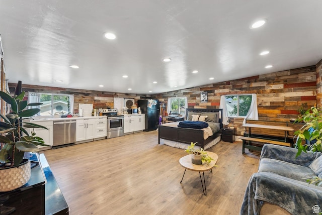 623 N 120 W, Lehi, UT 84043 - living room featuring light wood finished floors, wooden walls, and recessed lighting