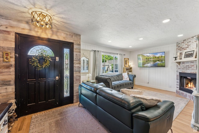 623 N 120 W, Lehi, UT 84043 - living area with wood finished floors, a textured ceiling, wooden walls, a fireplace, and baseboards