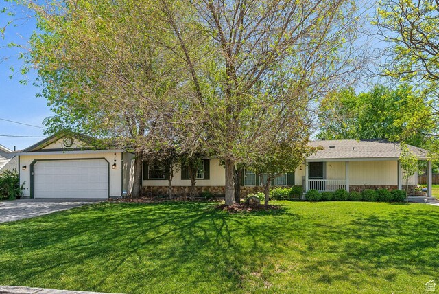 245 S 400 W, Heber City, UT 84032 - ranch-style home featuring stone siding, an attached garage, a front yard, and concrete driveway