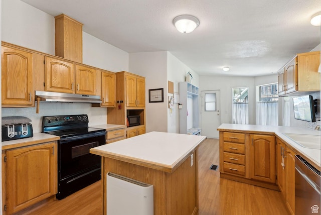245 S 400 W, Heber City, UT 84032 - kitchen featuring black appliances, light wood-style floors, under cabinet range hood, light countertops, and a center island