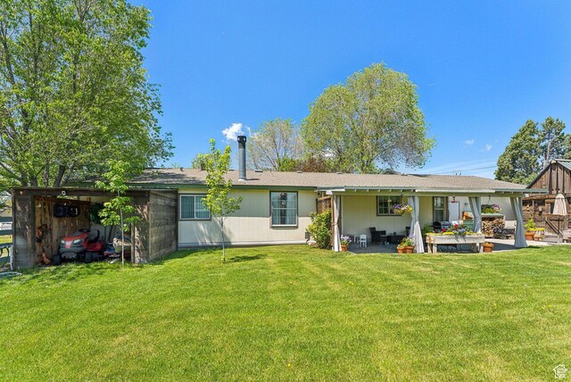 245 S 400 W, Heber City, UT 84032 - rear view of house with a lawn and a patio area