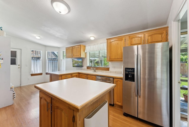 245 S 400 W, Heber City, UT 84032 - kitchen featuring stainless steel appliances, light countertops, light wood-style flooring, a peninsula, and a sink