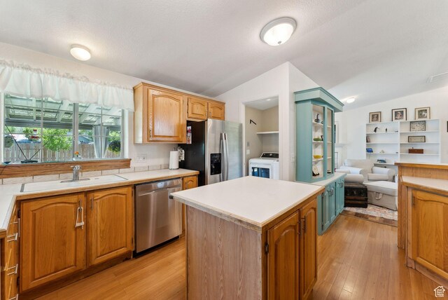 245 S 400 W, Heber City, UT 84032 - kitchen featuring appliances with stainless steel finishes, vaulted ceiling, a sink, and light countertops