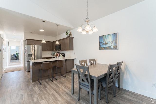 1994 N 3330 W Unit A304, Lehi, UT 84043 - dining space featuring light wood-style floors, a chandelier, baseboards, and lofted ceiling