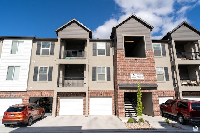 1994 N 3330 W Unit A304, Lehi, UT 84043 - view of building exterior featuring driveway and a garage