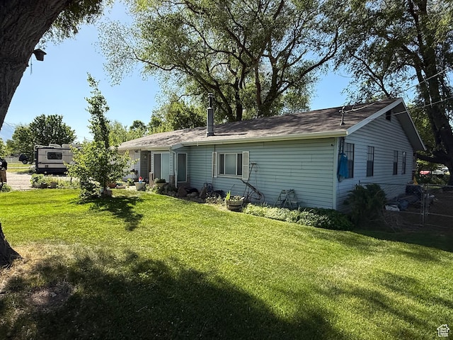 1035 W Main St, Lehi, UT 84043 - rear view of house with a yard and roof with shingles