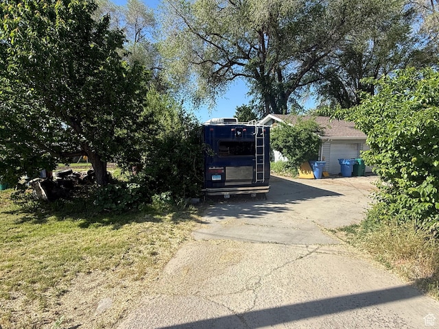 1035 W Main St, Lehi, UT 84043 - view of property hidden behind natural elements with asphalt driveway