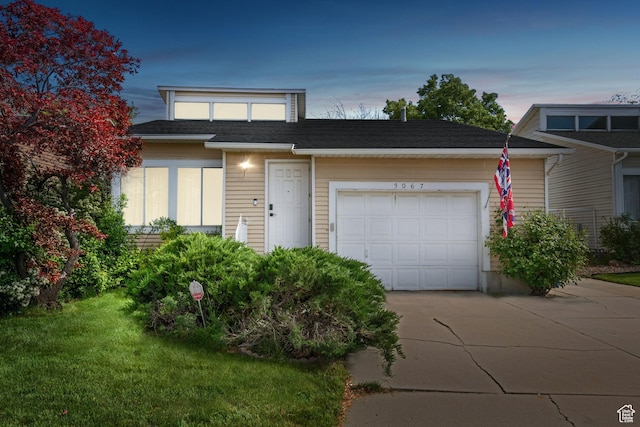 3067 W Sussex Pl, Taylorsville, UT 84119 - view of front of property with concrete driveway, a garage, and a front yard