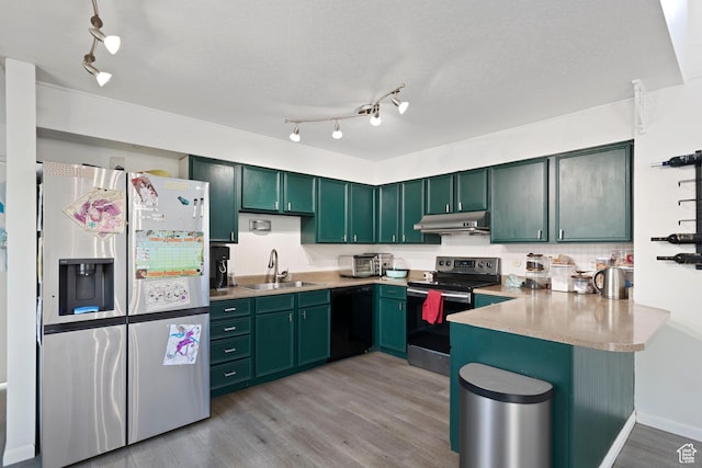 3067 W Sussex Pl, Taylorsville, UT 84119 - kitchen with stainless steel appliances, a sink, green cabinetry, a peninsula, and under cabinet range hood