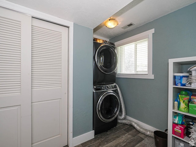 8701 S 1365 W, West Jordan, UT 84088 - laundry area featuring estacked washer and dryer, dark wood-style floors, and baseboards