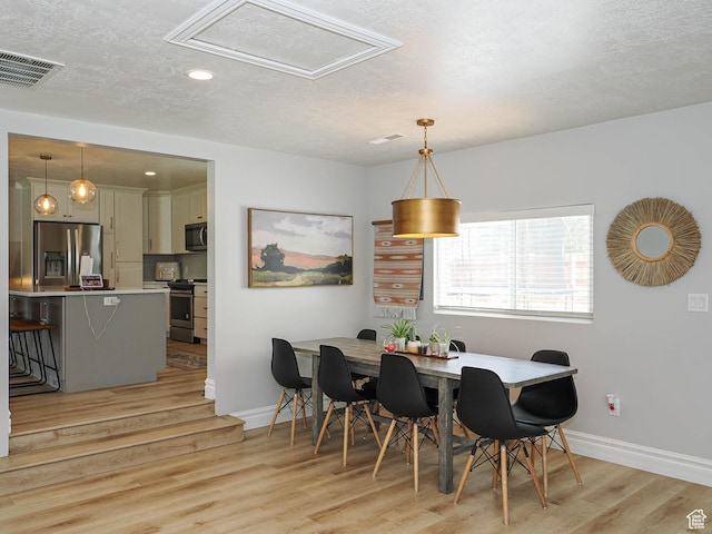 8701 S 1365 W, West Jordan, UT 84088 - dining room featuring a textured ceiling, baseboards, light wood-type flooring, and recessed lighting