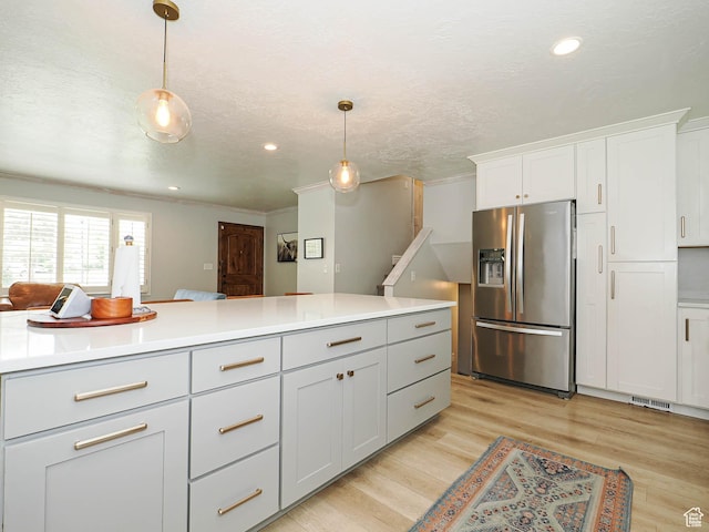 8701 S 1365 W, West Jordan, UT 84088 - kitchen with stainless steel refrigerator with ice dispenser, light wood-style floors, decorative light fixtures, light countertops, and white cabinetry