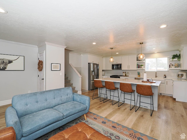 8701 S 1365 W, West Jordan, UT 84088 - living area featuring light wood-style flooring, recessed lighting, stairway, crown molding, and a textured ceiling