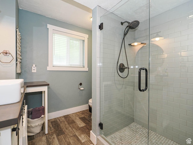 8701 S 1365 W, West Jordan, UT 84088 - full bath featuring wood finished floors, a shower stall, toilet, baseboards, and vanity