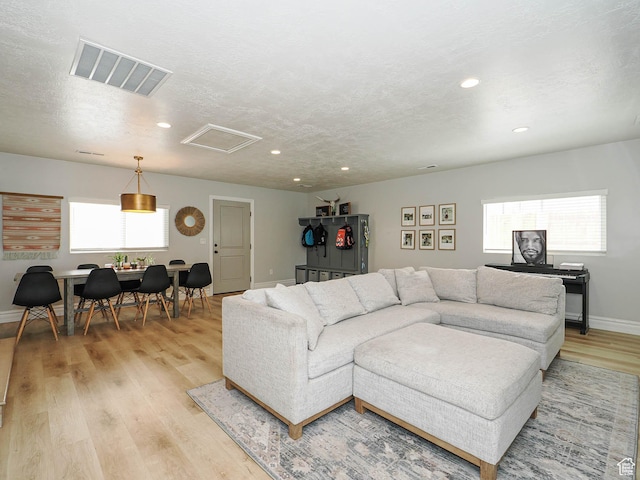 8701 S 1365 W, West Jordan, UT 84088 - living room with light wood finished floors, baseboards, recessed lighting, attic access, and a textured ceiling