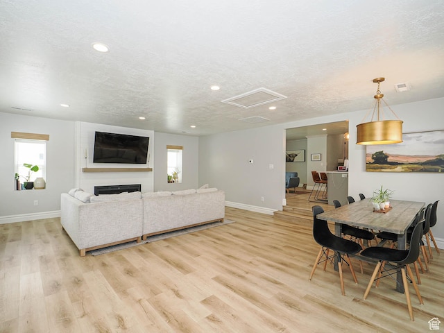 8701 S 1365 W, West Jordan, UT 84088 - living area with baseboards, attic access, light wood-type flooring, recessed lighting, and a textured ceiling